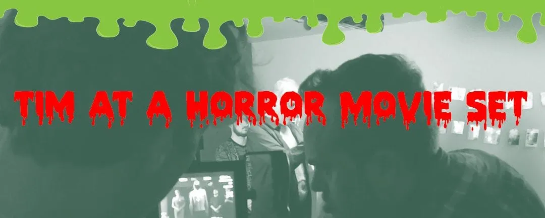 Film crew gathered around a monitor, with dripping red text “Tim at a horror movie set”